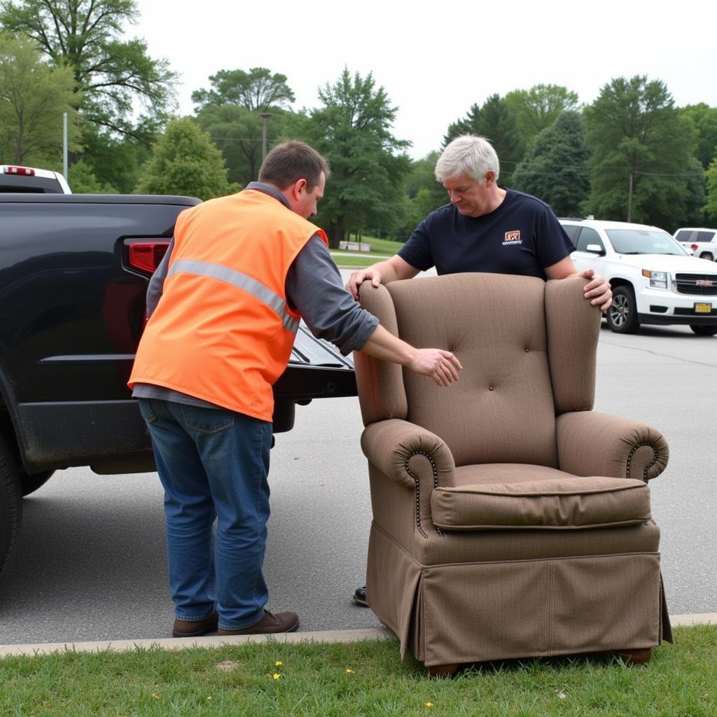 A volunteer helps a resident unload old furniture