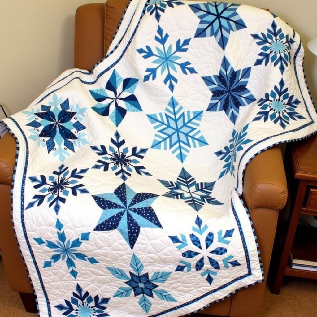 A finished paper pieced snowflake quilt draped over a chair