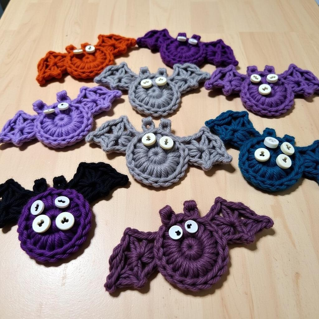 Several finished crochet bat appliques in various colors and sizes.