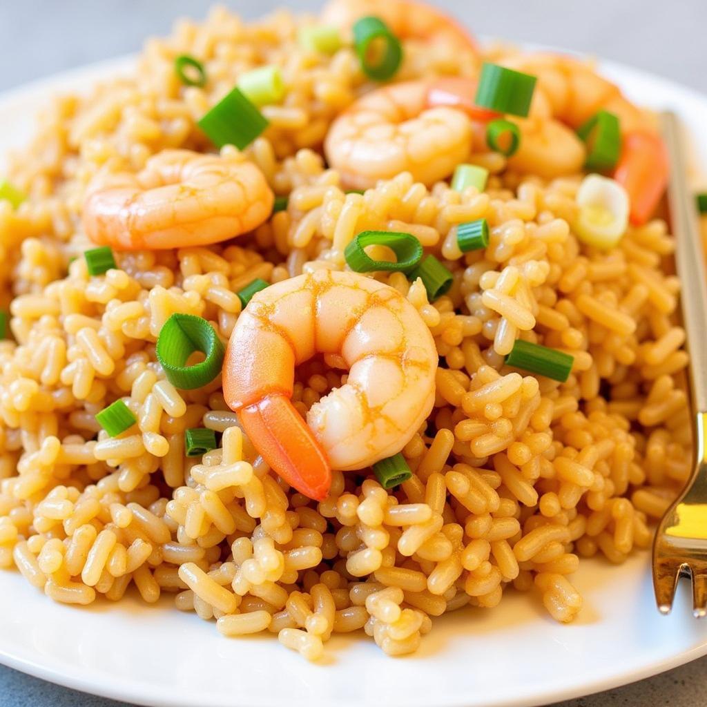 A plate of gluten-free shrimp fried rice garnished with green onions.