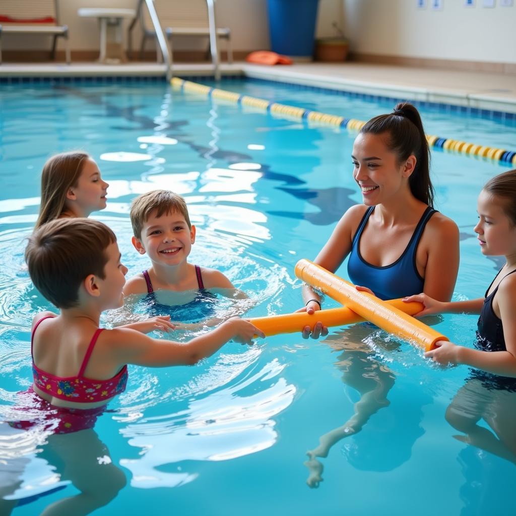 Children practicing swimming drills with pool noodles