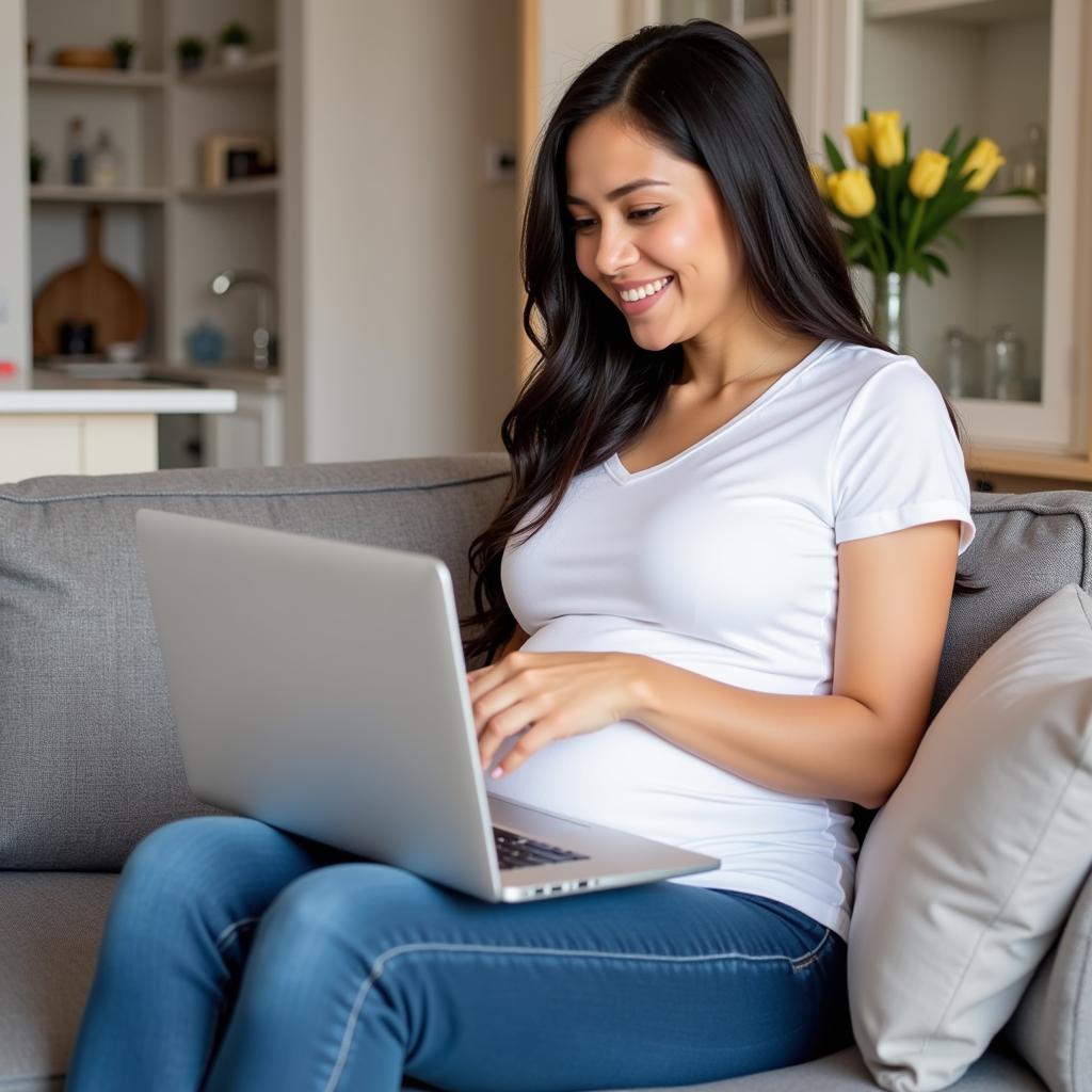 Pregnant woman researching free baby sample boxes on a laptop