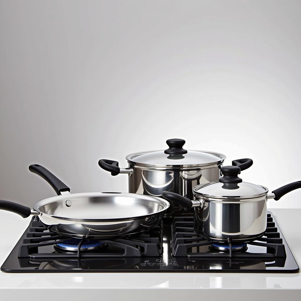 A set of gleaming nickel-free stainless steel cookware on a stovetop.