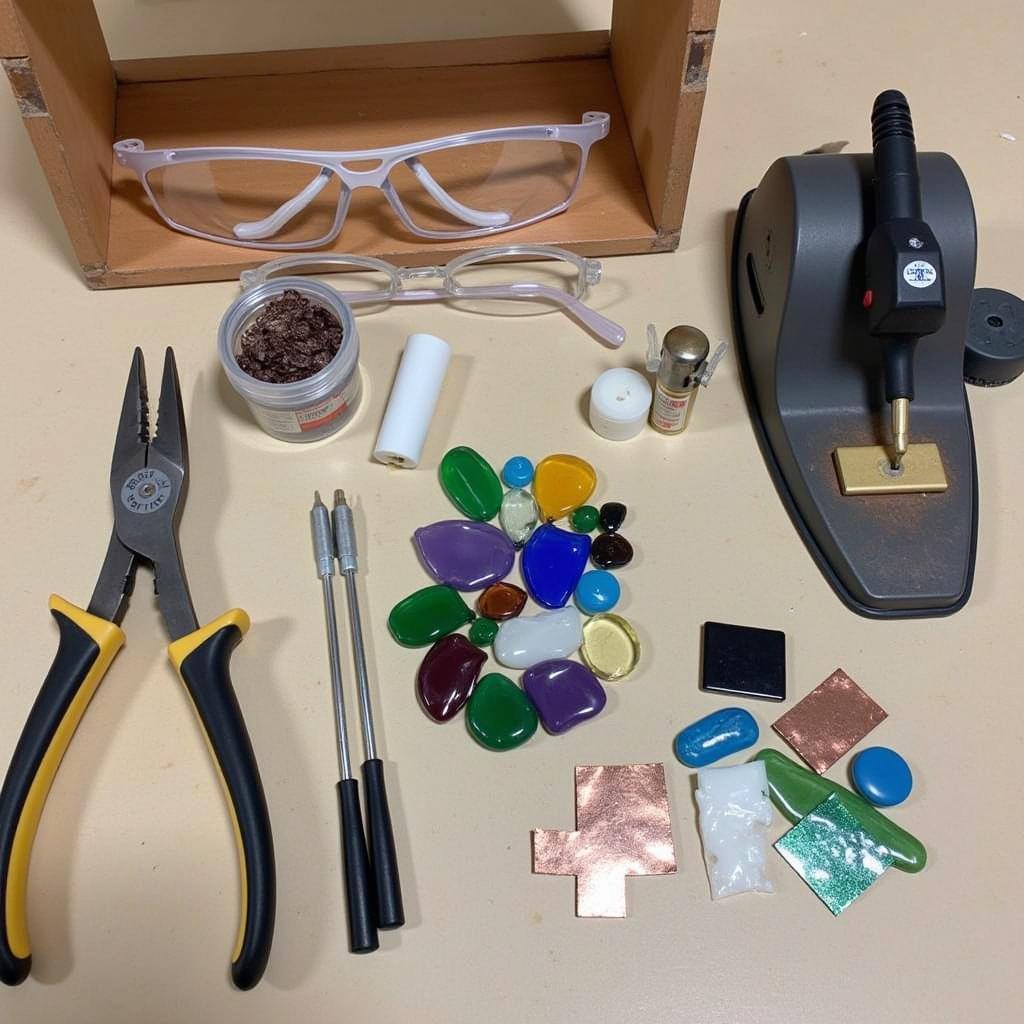 Essential tools and materials for stained glass projects, including glass cutter, soldering iron, and safety glasses.